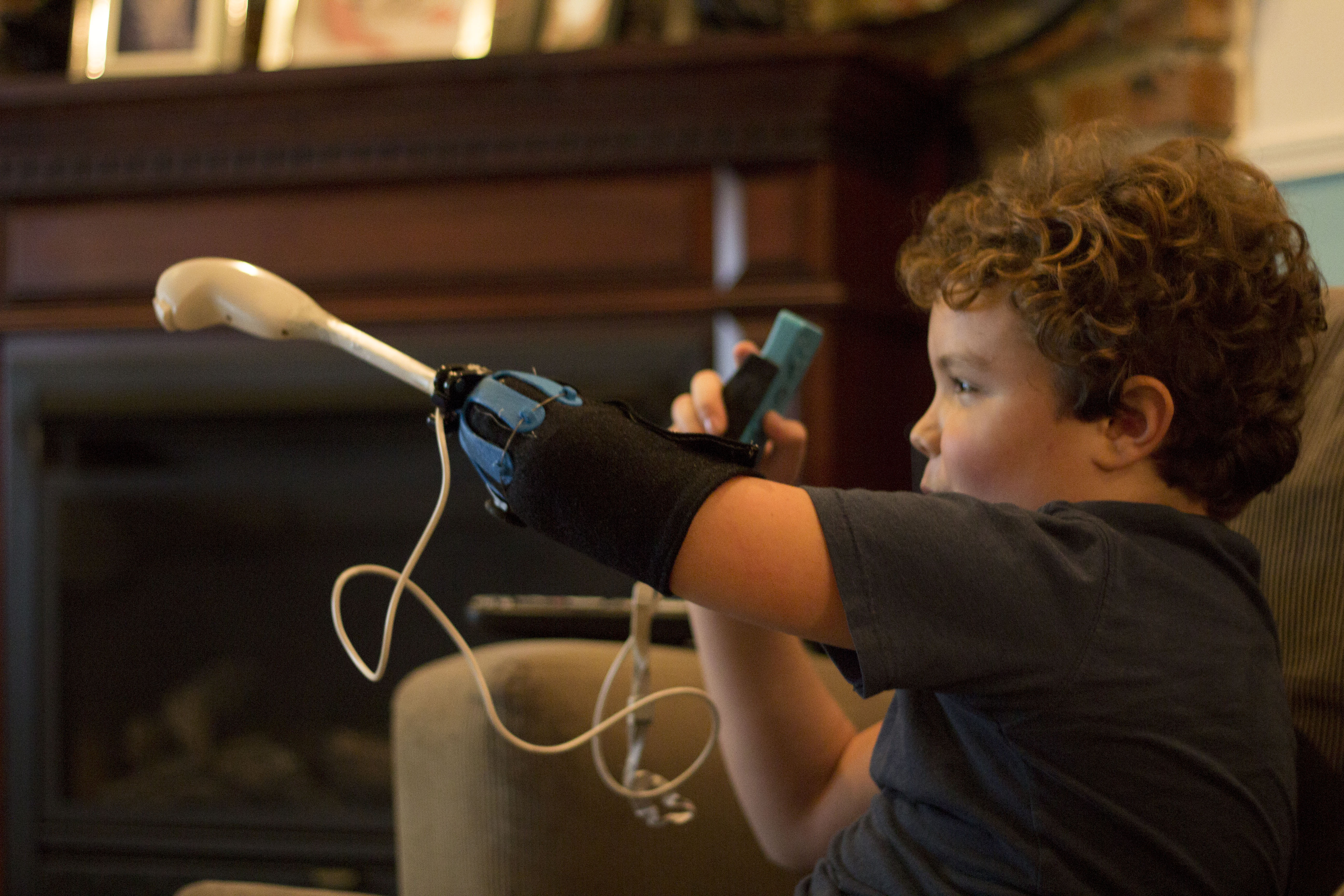 The Nintendo Wii uses a two handed interface. This attachment allows Payton to use both of the Wii controllers simultaneously. 