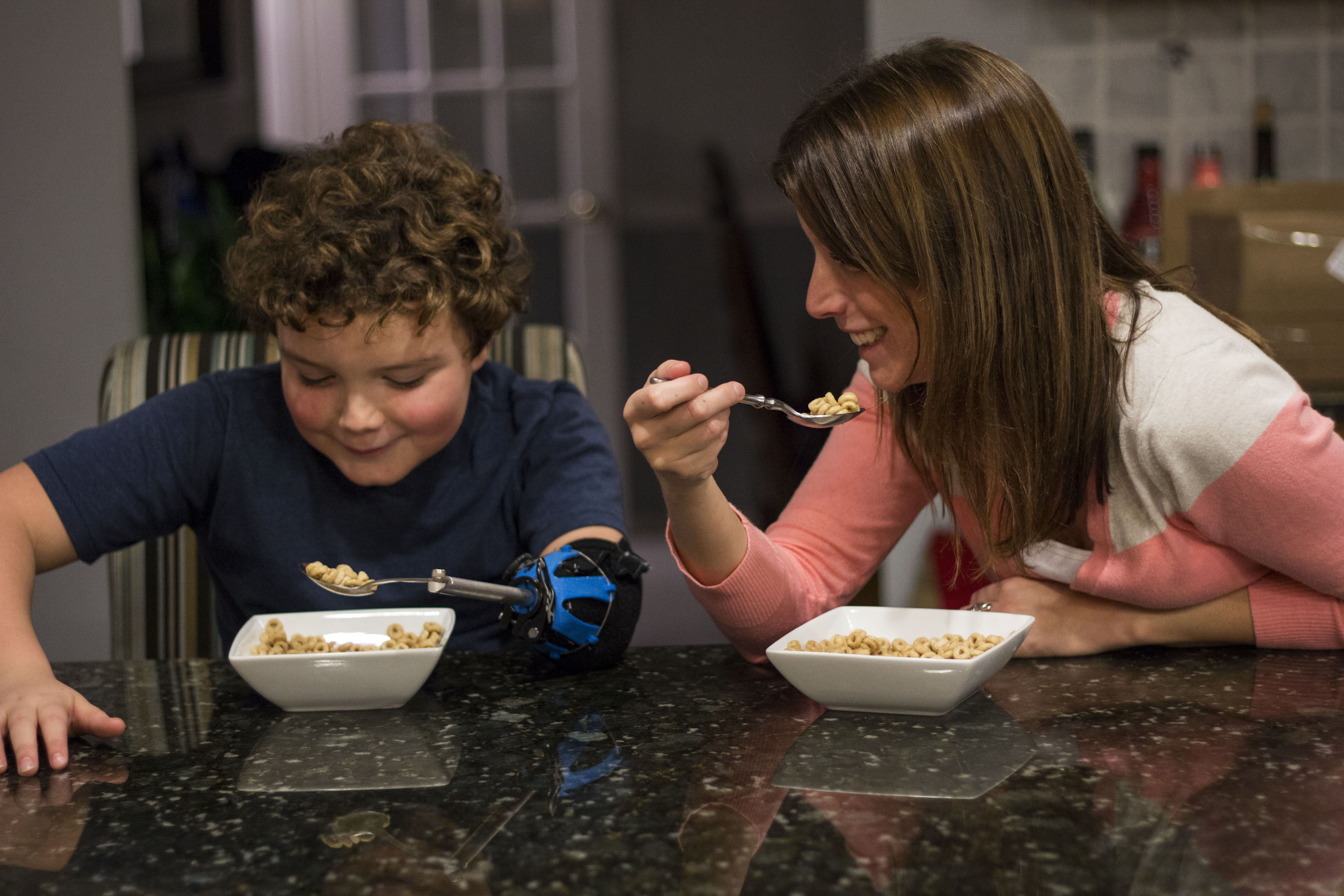 The spoon and fork attachments allow Payton to eat more effectively. 